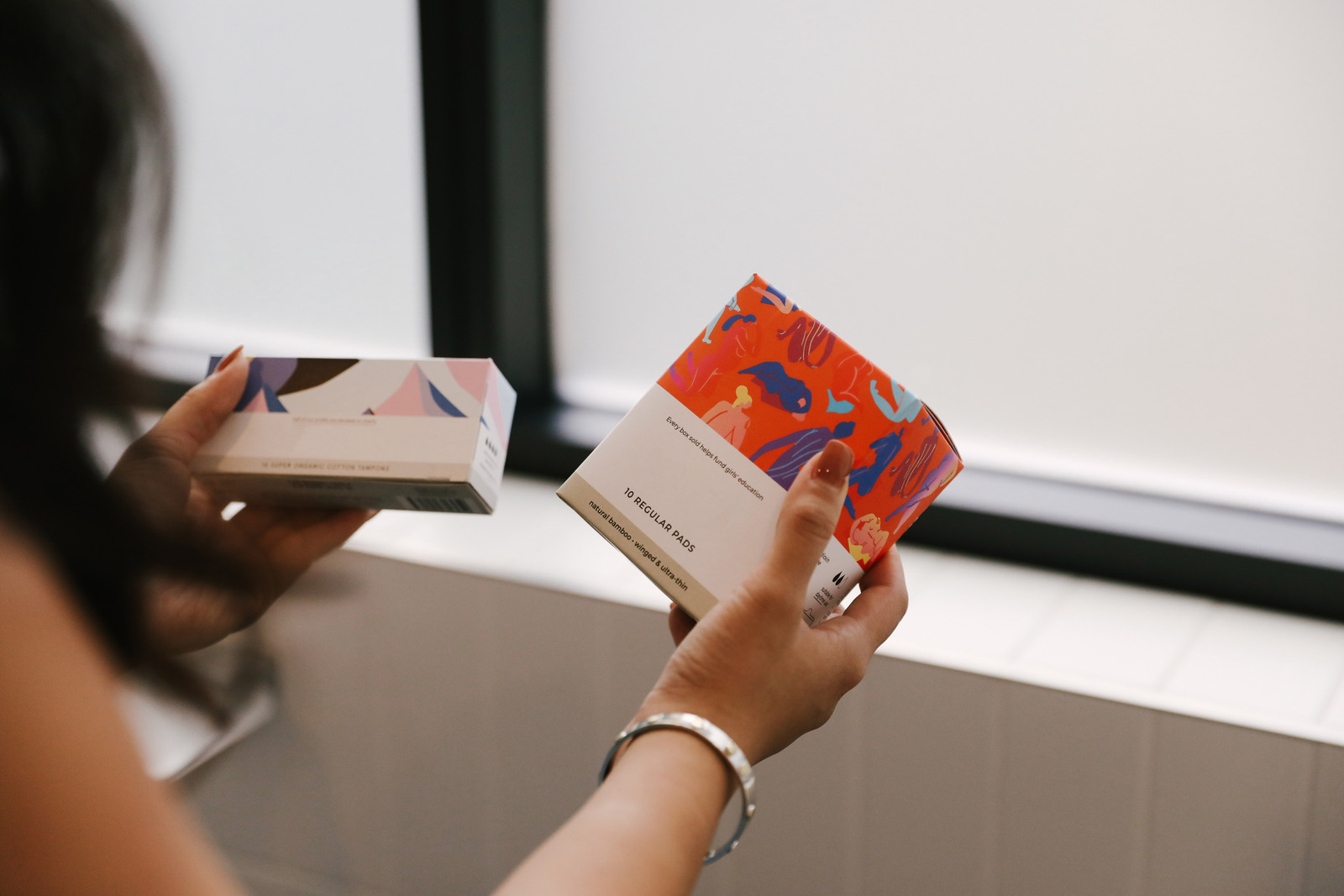 Women Comparing Box of Tampons - From Canva